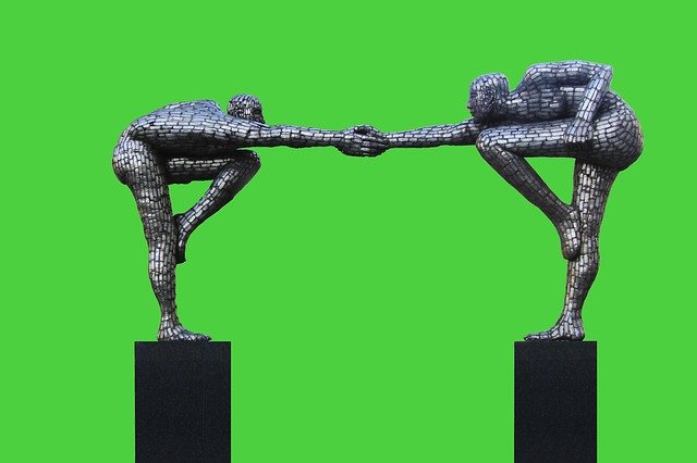 Two sculptures reaching out to each other